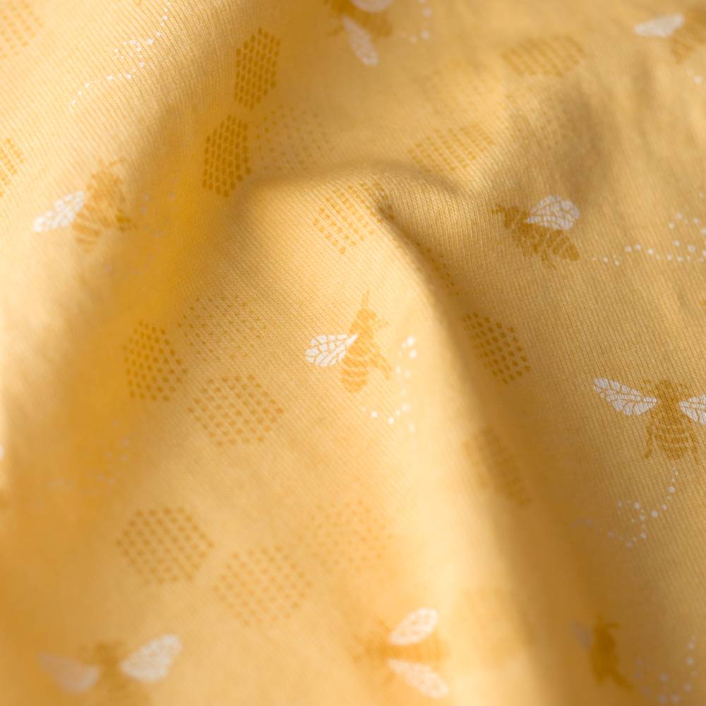 Close-up of yellow fabric with bee pattern