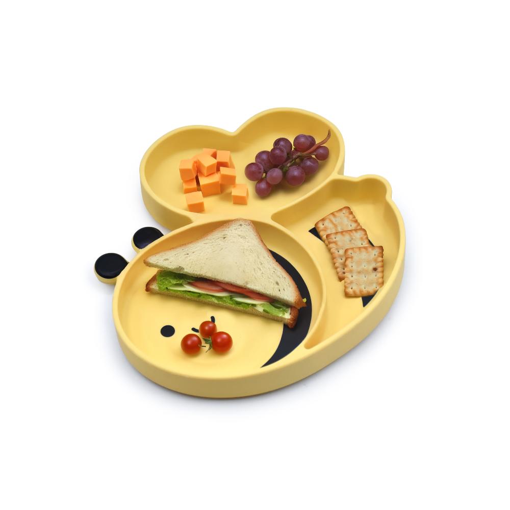Yellow children's bee shpaed divided plate with compartments filled with food on a white background