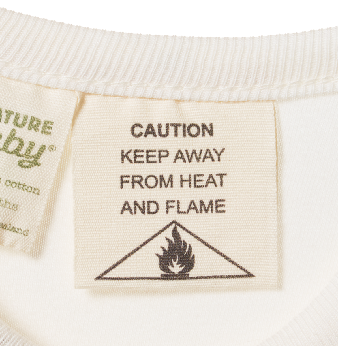 Textile label with 'Caution: Keep Away from Heat and Flame' warning on a white background