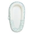 Baby slep pod with floral pattern on a white background