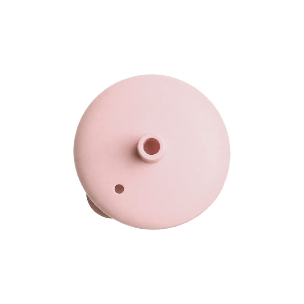 Pink silicone lid on a white background. 