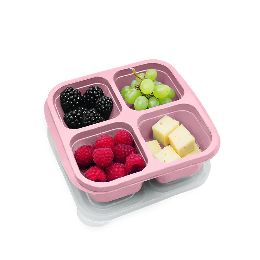 Pink compartmentalized snack container with fruits and cheese on a white background