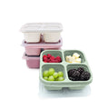 Pink and green compartmentalized meal prep container with fruits and a pink stacked container on a white background