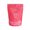 Pink protein powder bag against white background.