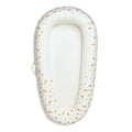 Baby nest with mesh base and animal pattern on a white background